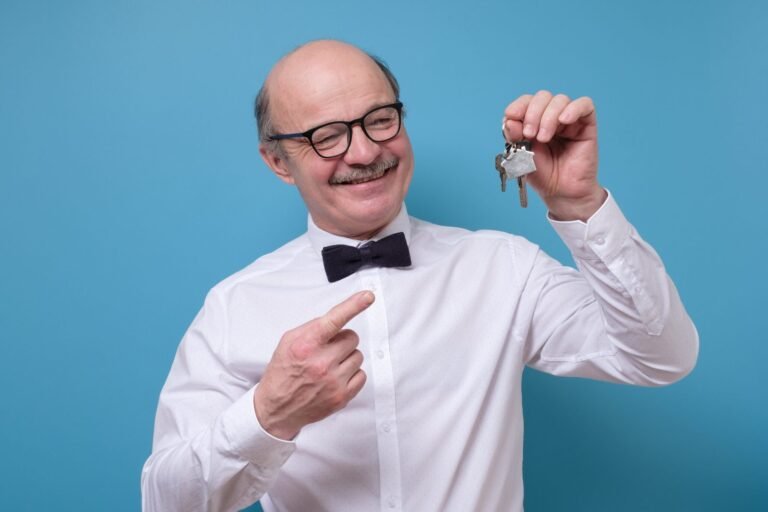 joyful senior man in glasses holding a key isolate 2023 11 27 04 56 06 utc scaled 1